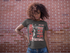files/mockup-of-a-woman-with-wind-in-her-hair-wearing-a-t-shirt-against-a-brick-wall-15814.png
