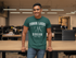 files/t-shirt-mockup-featuring-a-smiling-man-leaning-on-a-desk-at-the-office-28959_abb62338-1c15-4c7c-a940-d5a21854051a.png