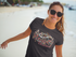 products/smiling-lovely-woman-wearing-a-t-shirt-mockup-and-sunglasses-at-the-beach-a12725_c6589cea-d23d-4d59-a3cd-6ac9e8beab95.png