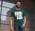 products/t-shirt-mockup-of-a-stylish-man-smiling-in-front-of-a-window-wall-21348.png