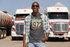 products/t-shirt-mockup-of-a-truck-driver-posing-in-front-of-two-trucks-29460.png
