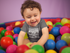 products/white-baby-boy-wearing-a-onesie-smiling-while-playing-in-the-ball-pit-mockup-14026.png