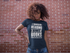 files/mockup-of-a-woman-with-wind-in-her-hair-wearing-a-t-shirt-against-a-brick-wall-15814_e04ce536-6104-49bb-9537-af5325fed295.png