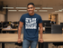 files/t-shirt-mockup-featuring-a-smiling-man-leaning-on-a-desk-at-the-office-28959_80c9b587-dce9-493b-b573-a0d2399f3e55.png