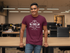 files/t-shirt-mockup-featuring-a-smiling-man-leaning-on-a-desk-at-the-office-28959_dbf41cfc-a922-4306-af10-e4ea73ca3474.png