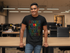 files/t-shirt-mockup-featuring-a-smiling-man-leaning-on-a-desk-at-the-office-28959_f17d001f-d967-4127-aee6-cb5e0d6fba54.png