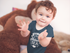products/baby-boy-clapping-sitting-down-wearing-a-onesie-with-a-monkey-plush-in-the-background-mockup-a14022.png