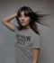 products/heathered-round-neck-tee-mockup-of-a-woman-posing-inside-a-studio-m4430-r-el2.png