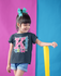 products/little-girl-wearing-a-t-shirt-mockup-a-hair-ribbon-and-rain-boots-in-a-bicolor-room-a19475.png
