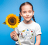 products/little-girl-with-braids-wearing-a-t-shirt-mockup-holding-a-sunflower-a19732.png