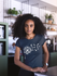 products/mockup-of-a-woman-with-curly-hair-wearing-a-t-shirt-at-a-startup-20406_9691c111-739f-4aec-8714-b3939fe3deeb.png