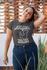 products/plus-size-t-shirt-mockup-of-a-happy-woman-in-her-patio-31034.png