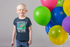 products/round-neck-tee-mockup-of-a-smiling-kid-with-glasses-standing-next-to-a-set-of-balloons-22057.png