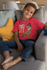 products/t-shirt-mockup-featuring-a-smiling-kid-sitting-on-a-couch-31639_9c7c1aa2-764e-4a16-89f1-42aded0c3d71.png