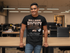 products/t-shirt-mockup-featuring-a-smiling-man-leaning-on-a-desk-at-the-office-28959_06859630-4235-4be3-914b-cbda644772c4.png