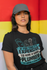products/t-shirt-mockup-featuring-a-woman-wearing-a-dad-hat-and-leaning-against-a-colorful-wall-28604.png