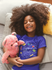 products/t-shirt-mockup-of-a-smiling-black-girl-with-curly-hair-on-bed-a21319.png
