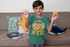 products/t-shirt-mockup-of-a-smiling-boy-playing-at-home-32166_29729279-950c-46d2-847c-f7a9f13c220c.png