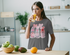 products/t-shirt-mockup-of-a-woman-drinking-orange-juice-in-the-kitchen-36341-r-el2.png