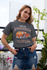 products/tee-mockup-of-a-girl-with-a-coy-smile-by-a-balcony-26628_2c3edf52-0261-4160-bab3-d3cc6ccbe692.png