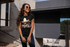 products/urban-mockup-of-a-smiling-girl-with-long-curly-hair-wearing-a-tshirt-24657.png